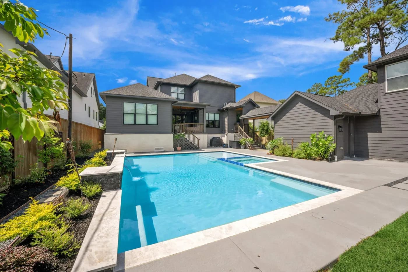 Custom pool and spa at twilight behind a Houston-area home built by Costa Maya Pools